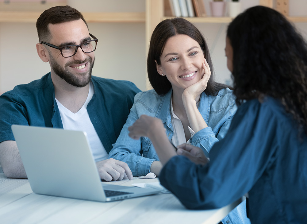 an insurance agent talking with clients about the importance of homeowners insurance