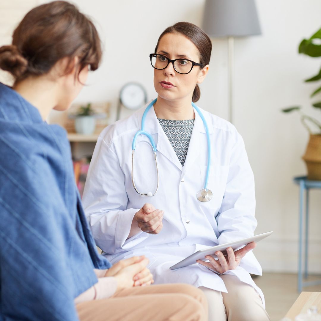 Female doctor speaking with a female patient