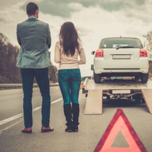 people watch car being towed