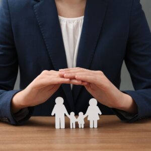 business woman shielding a symbol of a family